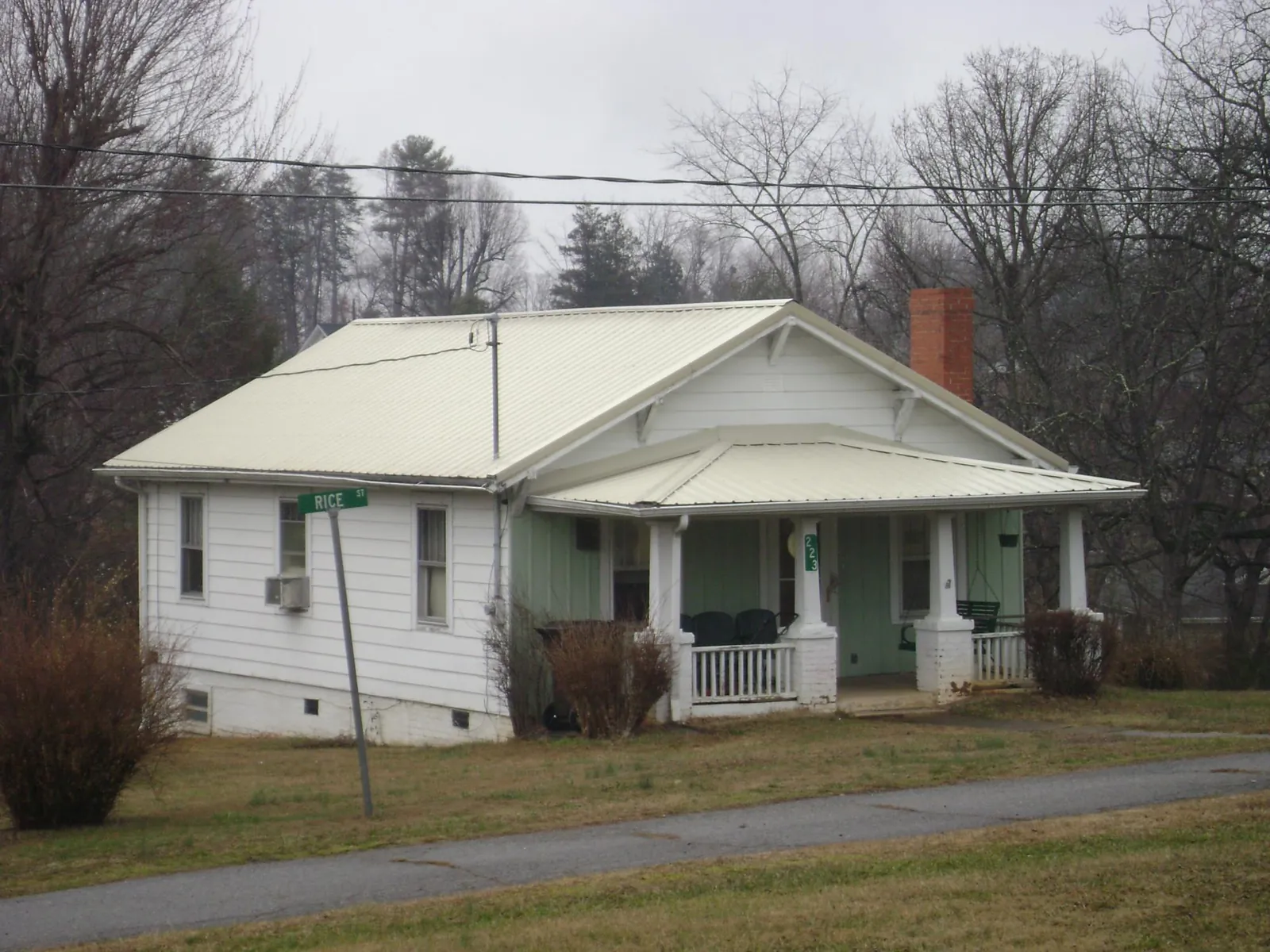 White metal roof on a craftsman bungalow at a street corner in Gifford