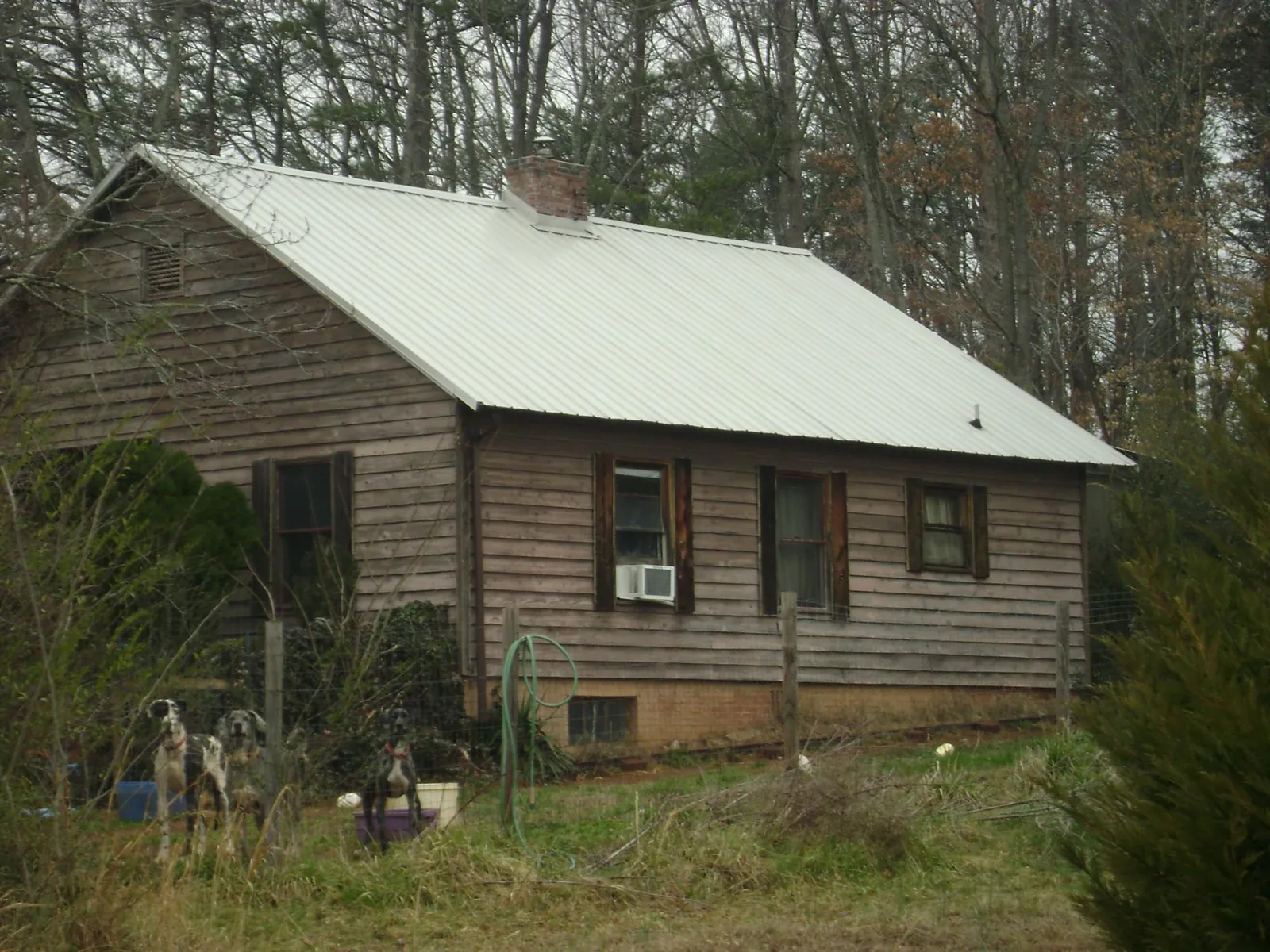 White metal roof on an old wood sided farmhouse, from a Metal Roof Installation job in Gifford